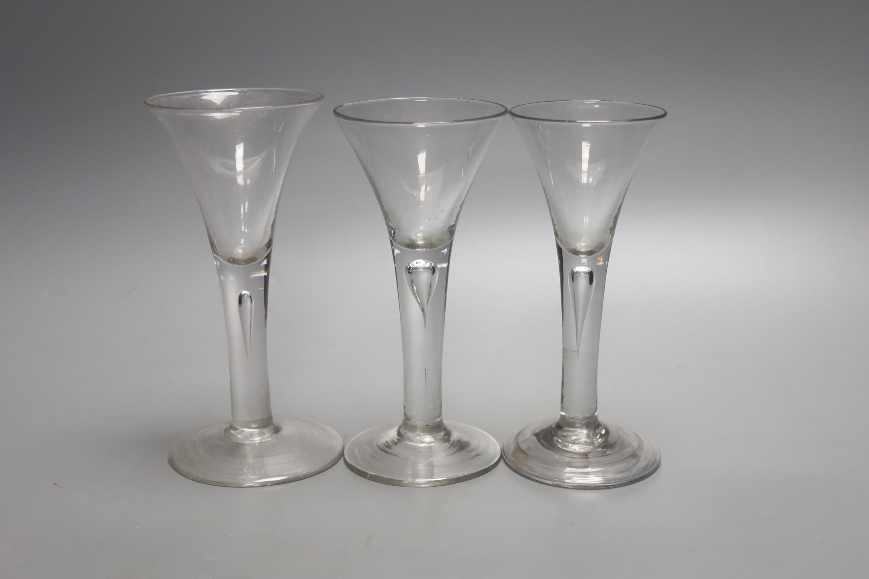 Three Georgian drawn trumpet ale glasses, tallest 17cm